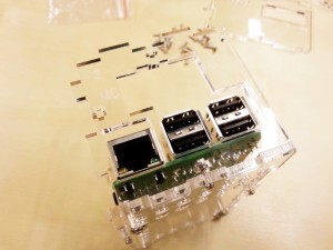Attach end plates, and ensure that the USB and Ethernet ports slide into the acrylic plate.