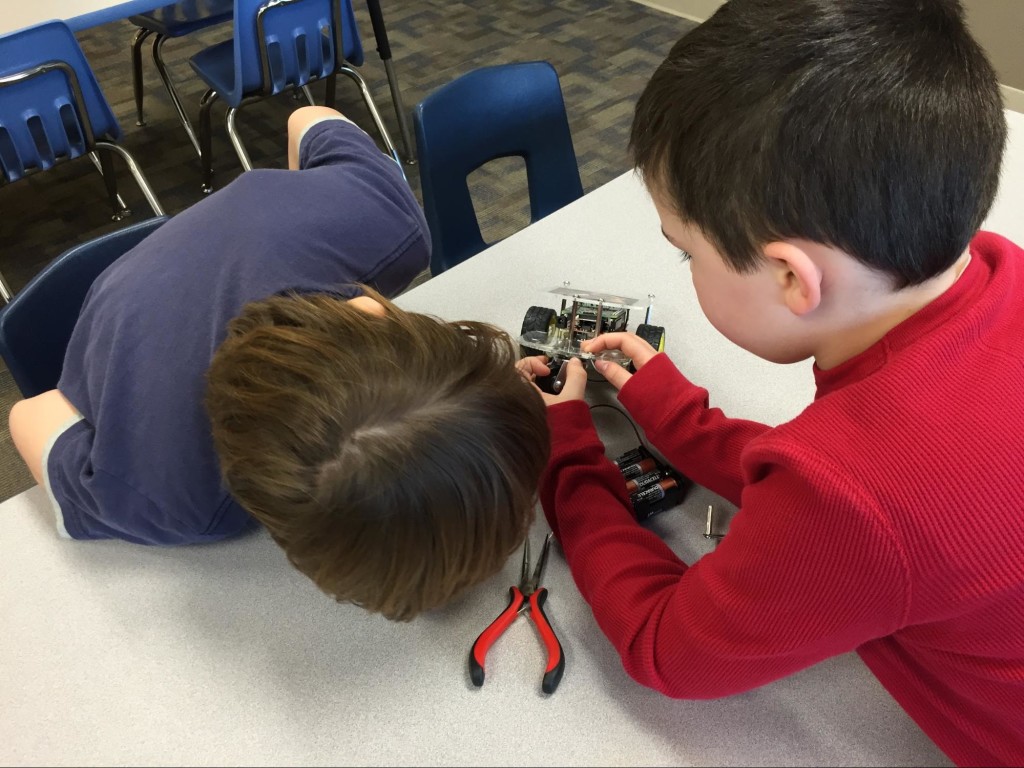 Landon and Brady installing the new caster on the GoPiGo.