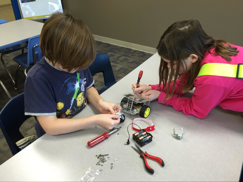 Landon and Riley attaching the new caster wheel